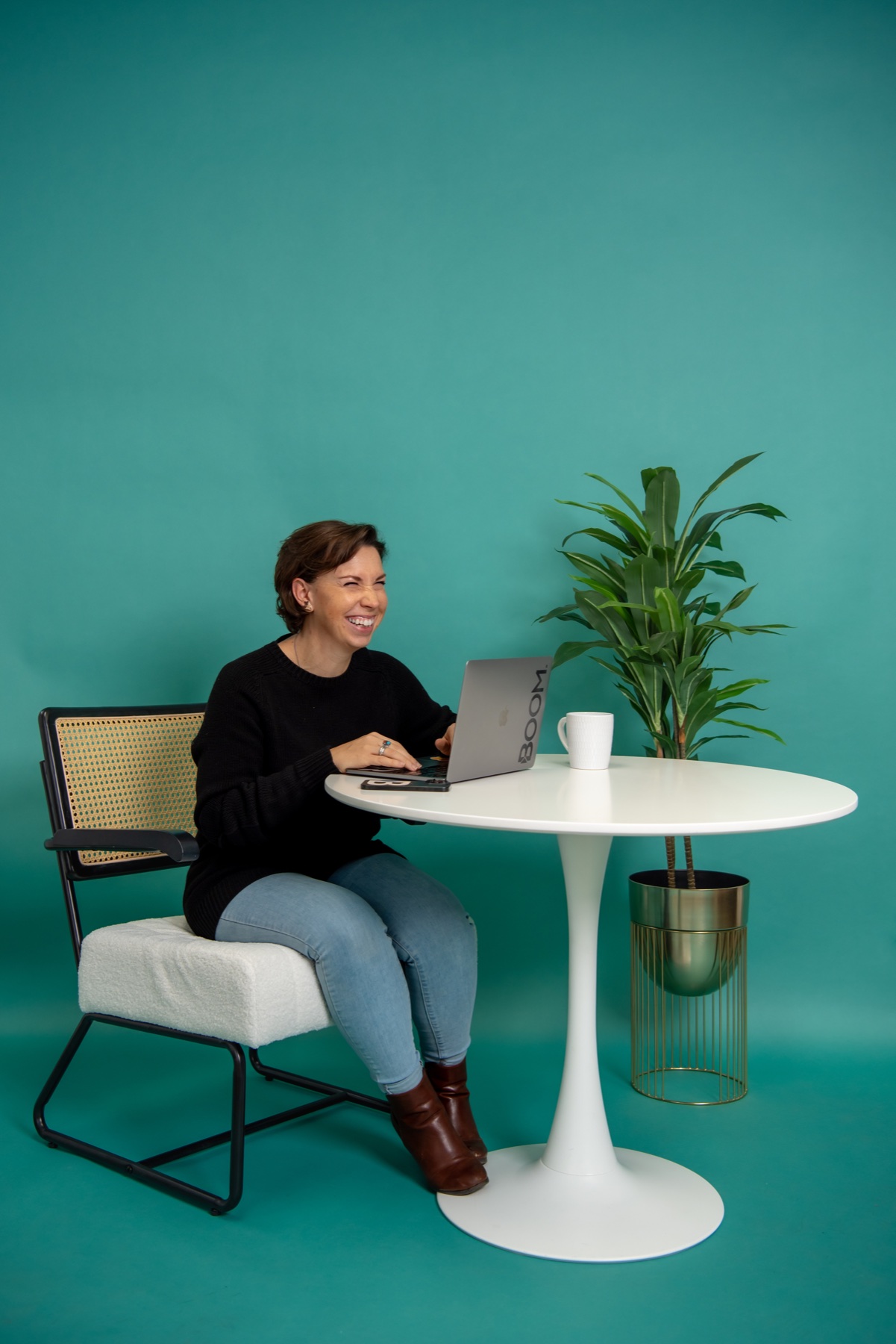 Boom team member smiling while working at her laptop